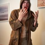 The Homeless Guy (Bill Moseley) is horrified to find his cup full of blood instead of coffee. 
Photo by Geoff George for Shaftesbury  
Copyright: Shaftesbury 
