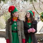 Isla (played by Isabella Gomez) and Kat (played by Laura Marano) take a walk in their work clothes.