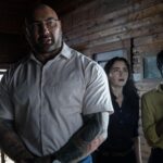 From left: Dave Bautista, Abby Quinn, and Nikki Amuka-Bird in KNOCK AT THE CABIN, directed and co-written by M. Night Shyamalan