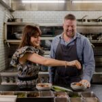 Zooey Deschanel and Chef Timothy Hollingsworth of Otium Restaurant, as seen on What Am I Eating? With Zooey Deschanel, Season 1.