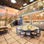 ‘Mystery Hotel Theme’ Set Plates of the Big Brother House for season 27 of the CBS Original Series BIG BROTHER, scheduled to air on the CBS Television Network.  Pictured: Rooftop Garden Kitchen: The kitchen and dining area mimic a rooftop garden with ivy-covered walls, sunset skies and a 10-foot round garden party table under string lights. Photo: Matthew Taplinger ©2025 CBS Broadcasting, Inc. All Rights Reserved.