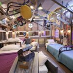 ‘Mystery Hotel Theme’ Set Plates of the Big Brother House for season 27 of the CBS Original Series BIG BROTHER, scheduled to air on the CBS Television Network.  Pictured: Attic Bedroom of Oddities: Beds made from wooden crates, rubber masks on the walls and haunted artifacts like a black knight’s helmet and diving suit make this room a spooky treasure trove. Photo: Matthew Taplinger ©2025 CBS Broadcasting, Inc. All Rights Reserved.