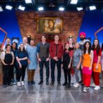 Hosts James Phelps and Oliver Phelps pose with contestants Alex Madrigal, Jenny Chambers, Rui Mota, Angel Figueroa, Jaleesa Mason, Caitlin Taylor, Stefan Rose, Andy Ortega, Marjorie Santaromana, Sarah Arnold, Katie Bonzer, Jujhar Mann, Kate Sigel, Heather Tocco, Molly Robbins, and Priya Winsor, as seen on Harry Potter: Wizards of Baking, Season 2.