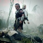 (L-R) Dek (Dimitrius Schuster-Koloamatangi) and Thia (Elle Fanning) in 20th Century Studios' PREDATOR: BADLANDS film. Photo courtesy of 20th Century Studios. © 2025 20th Century Studios. All Rights Reserved.