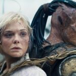 (L-R) Thia (Elle Fanning) and Dek (Dimitrius Schuster-Koloamatangi) in 20th Century Studios' PREDATOR: BADLANDS film. Photo courtesy of 20th Century Studios. © 2025 20th Century Studios. All Rights Reserved.