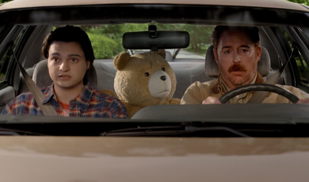 TED -- S2 -- Pictured: (l-r) Max Burkholder as John, Seth MacFarlane as voice of Ted, Scott Grimes as Matty -- (Photo by: Peacock)